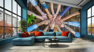 Top view of a business team with hands together in the office. A diverse group of people working and showing the unity concept Wall mural