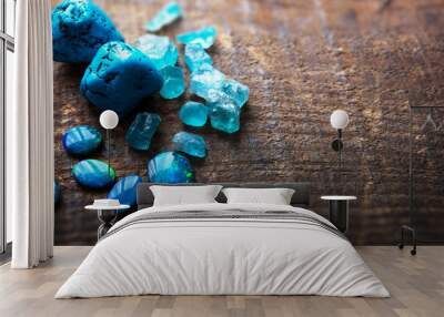 Blue gems on rustic wooden table. Treasure hunting. Mining for gems. Blue Turquoise, blue opals and apatite stones on a wooden table. Shallow depth of field. Wall mural