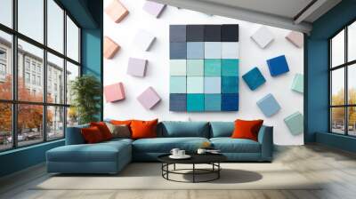 Color selection.  Grey and light blue color sample cubes arranged on a natural white background, with pink, white, and blue grey cubes surrounding it.  flat lay or top view. Wall mural