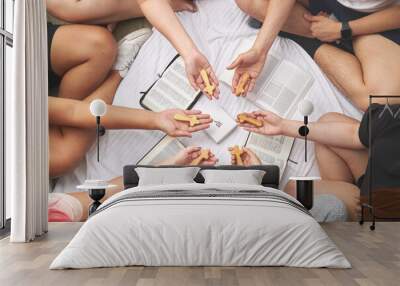 Overhead shot of a group of religious people holding wooden crosses over bibles Wall mural