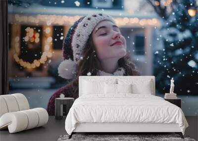 Young woman smiling in snow on Christmas Eve Wall mural