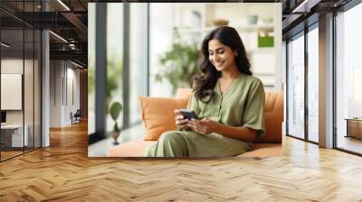 A portrait of an indian lady using a smart home app on his phone sitting on a couch,  Wall mural