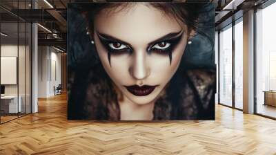 A woman showcasing her Halloween makeup with a spooky vampire look, including fangs and dark, dramatic eyes. Wall mural