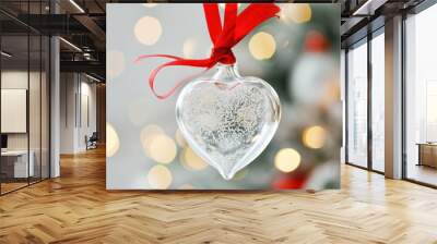 clear glass sphere bauble ornament in heart shape with light reflections hanging on a red ribbon on white background  Wall mural