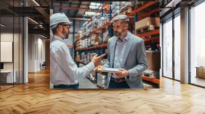 Experienced warehouse manager discussing logistics with staff members.  Wall mural