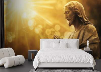 Jesus Christ in a serene pose, with hands folded in prayer, against a radiant background symbolizing divine light. Wall mural