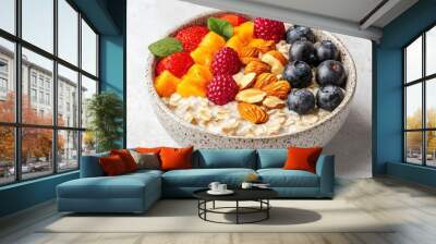 Bowl of oatmeal topped with fresh fruits and nuts, healthy breakfast option. Wall mural