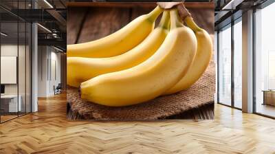 A bunch of ripe bananas on a rustic wooden surface. Wall mural