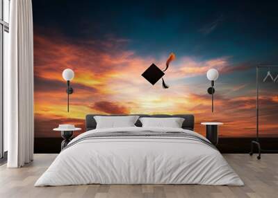 A graduation cap floats against a vibrant sunset, symbolizing achievement and new beginnings. Wall mural