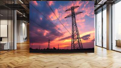 A power transmission tower silhouetted against a vibrant sunset sky. Wall mural