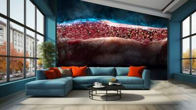 A raw steak with spices, presented dramatically against a dark background. Wall mural