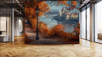 A scenic autumn view along a river, showcasing vibrant foliage and historic architecture. Wall mural