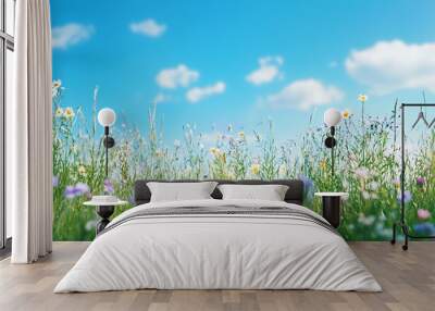 A vibrant meadow filled with colorful wildflowers under a clear blue sky. Wall mural