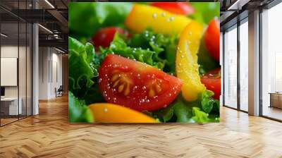 A vibrant salad featuring fresh greens, tomatoes, and yellow peppers, sprinkled with salt. Wall mural