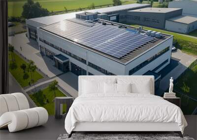 An aerial view of a modern industrial building with solar panels on the roof. Wall mural