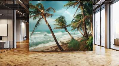 Palm trees bend over a sandy beach with stormy waves crashing. Wall mural