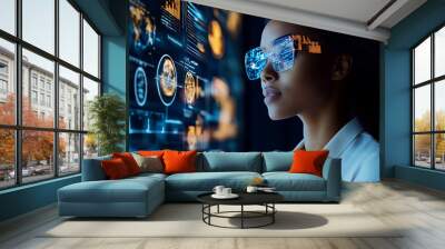 Woman wearing futuristic glasses looking at computer screen with data visualizations. Wall mural