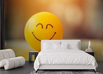 Yellow smiley face on wooden table with blurred background. Wall mural