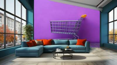 A silver shopping cart stands in front of a purple wall. Wall mural