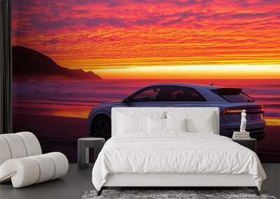 A silver SUV parked on a sandy beach at sunset, with a dramatic orange and red sky. Wall mural