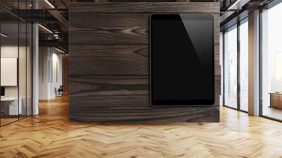 Black tablet computer on wooden dark background with space for text, flat lay Wall mural