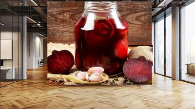 pieces of garlic, beets, spices next to the jar with pickled beets in the jar Wall mural