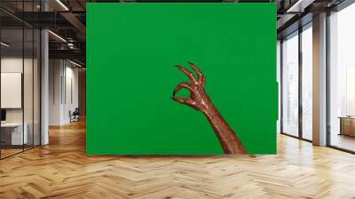 Creepy halloween monster hand in glitter slime with nails shows ok good sign isolated on chroma key green screen background, workspace mockup. Wall mural