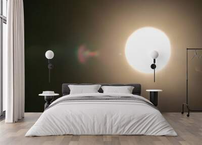 Real optical lens flare on black background Wall mural