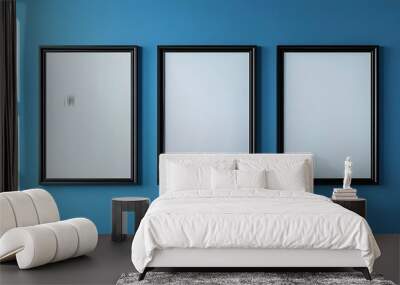 Three empty vertical black frame mockup design on a blue wall room, 3d render of grey interior with canvas on the wall  Wall mural