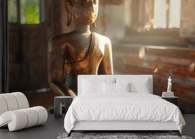 An old Buddha statue sits on an old wooden table. Wall mural