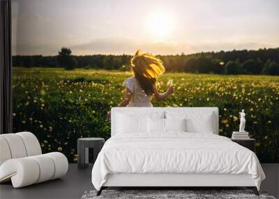 girl at sunset in field Wall mural