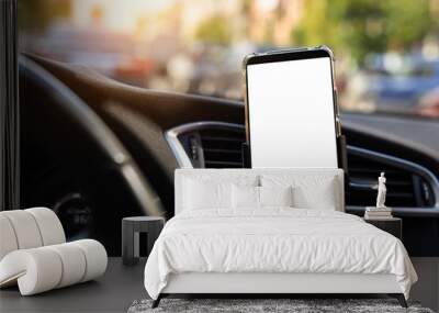 Modern smartphone device gadget mounted on phone holder at car dashboard. Mock-up white screen isolated template. Copyspace for text . Vehicle interior cockpit view. Traffi jam info app Wall mural