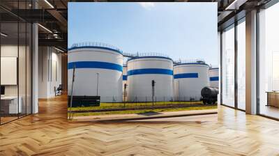 Row many large industrial fuel storage white tanks clear blue sky background on sunny day. Oil storage refinery depot liquid facilities. Energy hazmat railroad transportation storage and distribution Wall mural