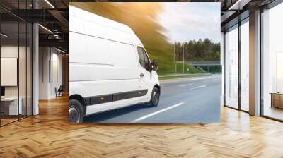 White modern delivery small shipment cargo courier van moving fast on motorway road to city urban suburb. Busines distribution and logistics express service. Mini bus driving on highway on sunny day Wall mural