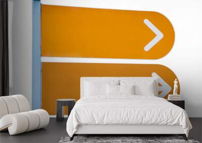 sign post with two white arrows on an orange background Wall mural