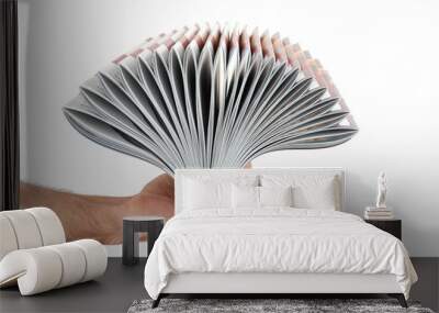 Pile of magazines in hand isolated over white Wall mural