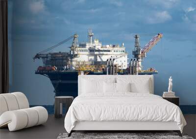 Offshore Accommodation platform pumping water at sea on cloudy day Wall mural