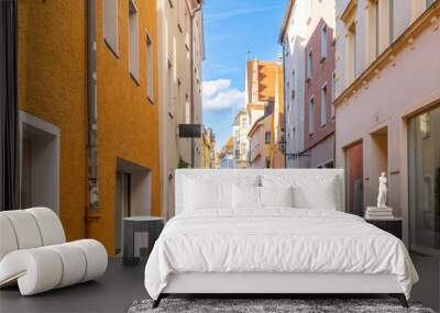 A narrow alley full of colorful shop and cafes in the historic Altstadt old town of the Bavarian city of Regensburg, Germany, on the banks of the Danube River. Wall mural