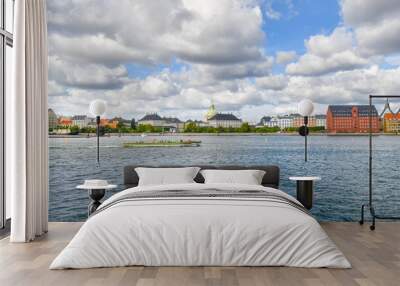 A tourist cruise boat floats past Amalienborg castle and the Marble or Frederik's Church on the water near Holmen Island harbor in Copenhagen Denmark. Wall mural