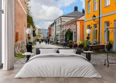 Colorful and picturesque shops, cafes and wooden buildings line the main cobblestone road through the medieval Old Town of Porvoo, Finland. Wall mural