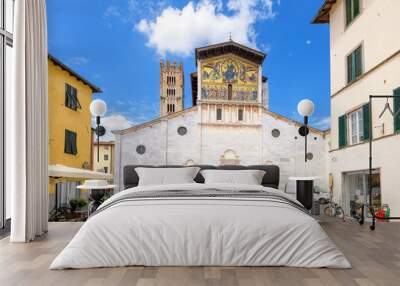 Piazza San Frediano with the facade and bell tower of the San Frediano Basilica, a Romanesque church with golden mosaic facade, inside the walled medieval town of Lucca, Italy.	 Wall mural