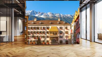 Snow capped mountains in early autumn above the historic Goldenes Dachl or Golden Roof in the medieval old town of Innsbruck, Austria, in the Austrian Alps. Wall mural