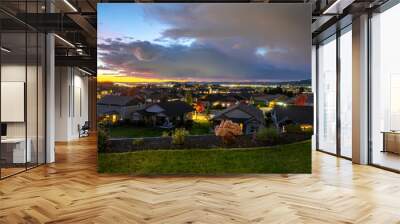 Sunset evening view of a lit up subdivision, Spokane and Spokane Valley from a hilltop in Liberty Lake, Washington, USA Wall mural