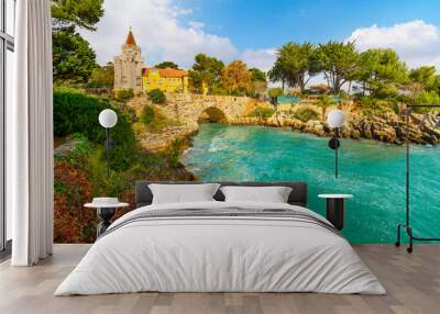 View from a small bay and cove along the rocky coastline of the Palace of Condes de Castro Guimaraes, a seaside museum along the Riviera at Cascais, Portugal. Wall mural