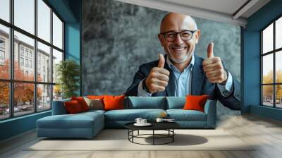 A man in a suit and glasses gives a thumbs up. Wall mural