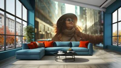 Fashionable woman in a stylish hat and sunglasses enjoying a sunny winter day in the city streets Wall mural