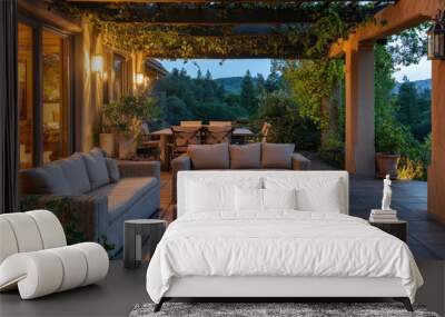 Patio scene with a modern couch and coffee table under a striped umbrella, surrounded by lush green plants and soft ambient lighting. Wall mural