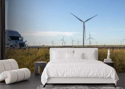 Semi-Truck Driving Past Wind Turbines on a Sunny Day in a Renewable Energy Landscape Wall mural