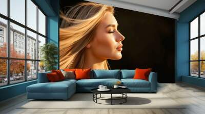 side view of a woman with flowing blonde hair basking in golden sunlight Wall mural