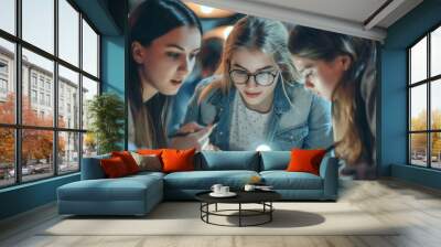 Three young Caucasian women engaging in a focused study session at night, illuminated by a single light source. Wall mural